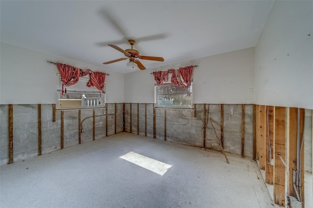 interior space with ceiling fan