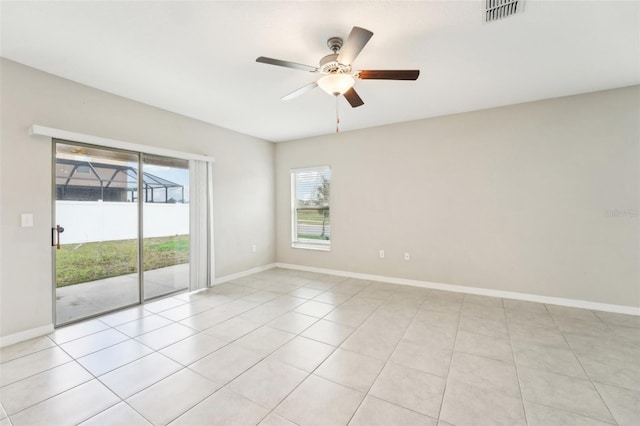 empty room featuring ceiling fan and light tile patterned floors