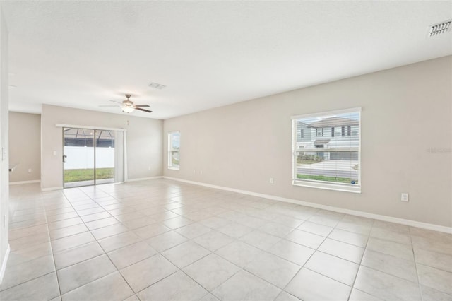 tiled empty room featuring ceiling fan