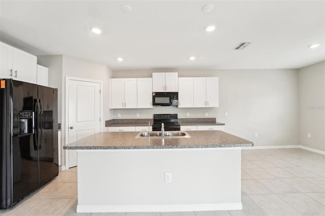 kitchen with sink, a center island with sink, white cabinets, and black appliances