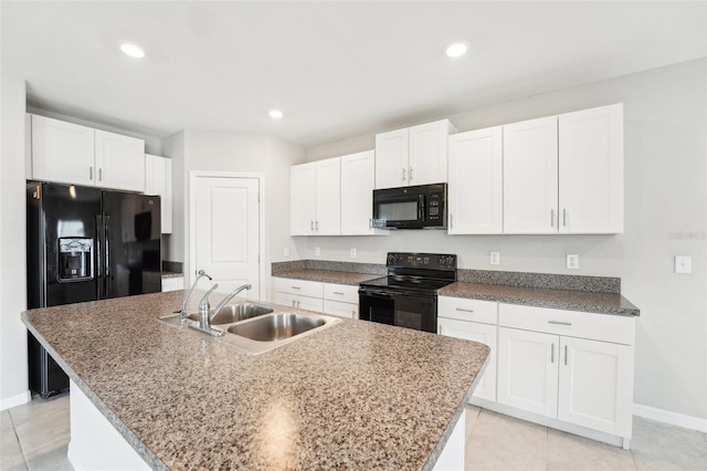 kitchen featuring sink, a center island with sink, white cabinets, and black appliances