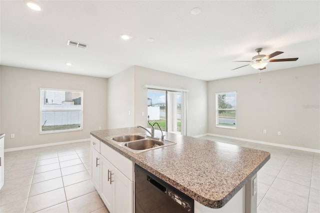 kitchen with light tile patterned flooring, sink, white cabinetry, a center island with sink, and dishwasher