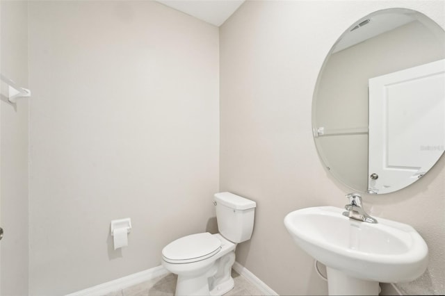 bathroom featuring sink, tile patterned floors, and toilet