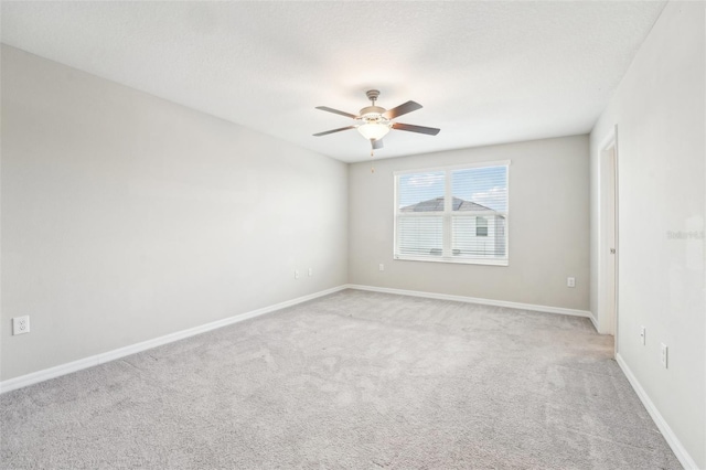 carpeted spare room featuring a textured ceiling and ceiling fan