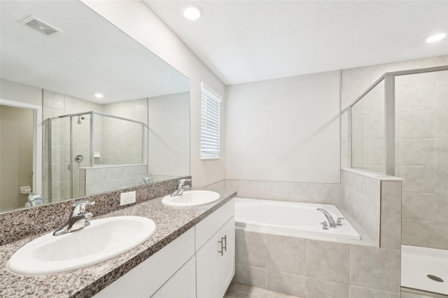 bathroom with shower with separate bathtub and vanity