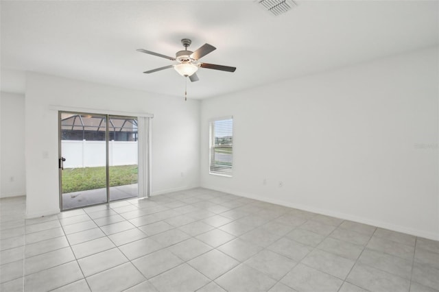 empty room with visible vents, ceiling fan, and baseboards