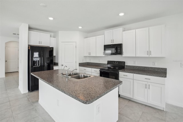 kitchen with a kitchen island with sink, a sink, white cabinets, black appliances, and dark countertops