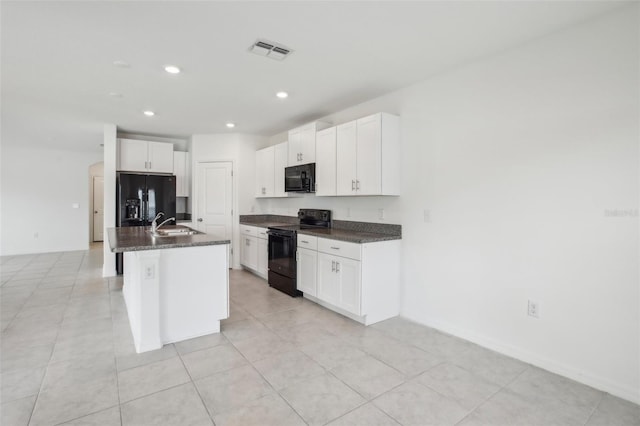 kitchen featuring black appliances, visible vents, white cabinetry, and a sink