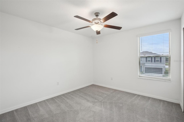 unfurnished room featuring carpet, baseboards, and a ceiling fan