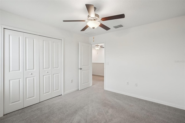 unfurnished bedroom featuring a closet, visible vents, baseboards, and carpet flooring