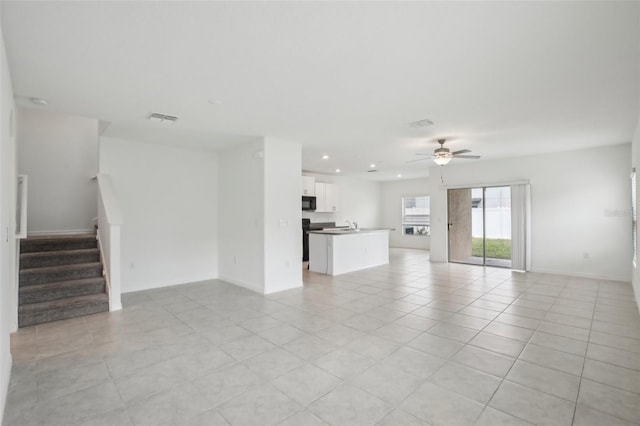 unfurnished living room featuring light tile patterned floors, visible vents, a ceiling fan, stairs, and recessed lighting