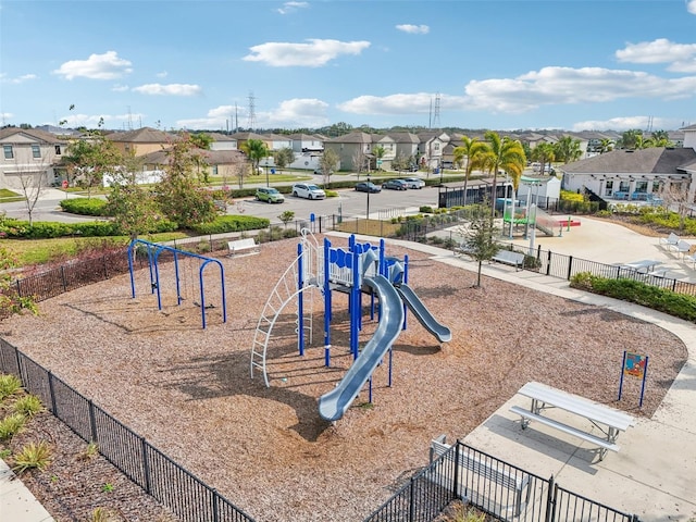 community jungle gym featuring fence and a residential view