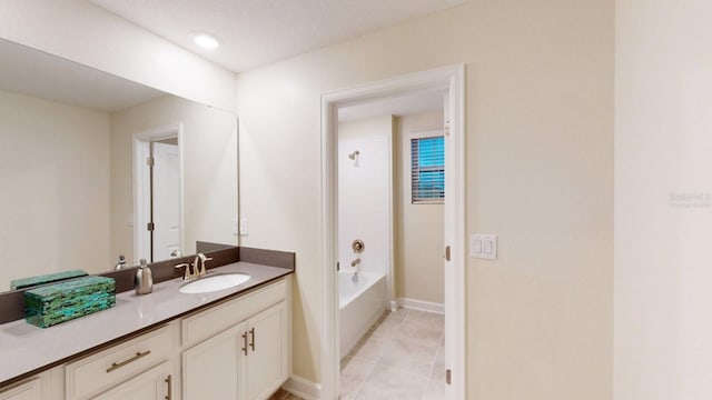 bathroom featuring vanity, tile patterned floors, and tub / shower combination