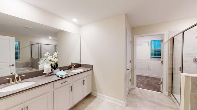 bathroom with independent shower and bath, vanity, and tile patterned flooring