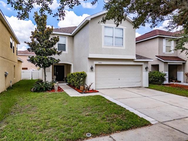 view of front facade with a garage and a front yard