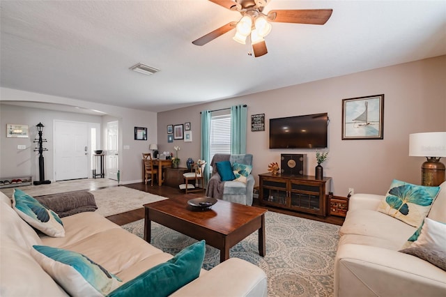 living room with hardwood / wood-style flooring and ceiling fan