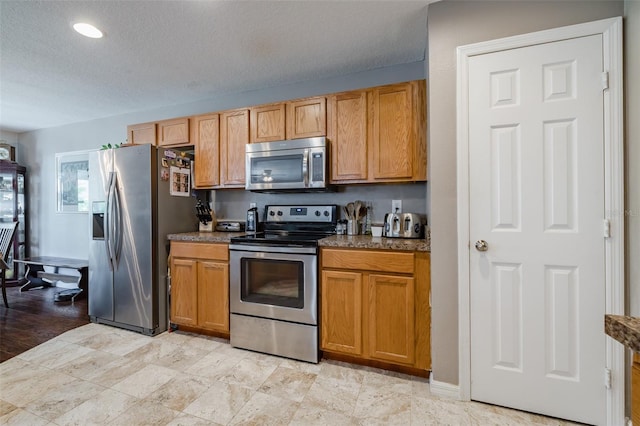 kitchen featuring appliances with stainless steel finishes and a textured ceiling