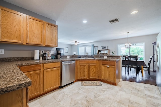 kitchen featuring sink, ceiling fan with notable chandelier, dishwasher, decorative light fixtures, and kitchen peninsula