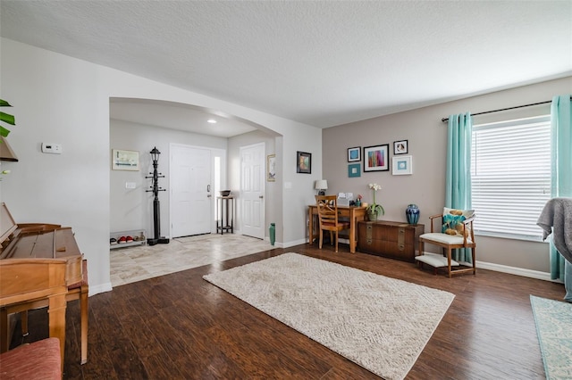 foyer with hardwood / wood-style flooring and a textured ceiling