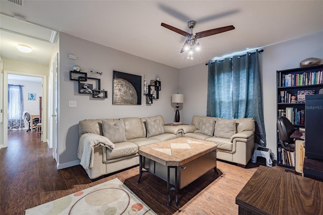 living room featuring wood-type flooring and ceiling fan