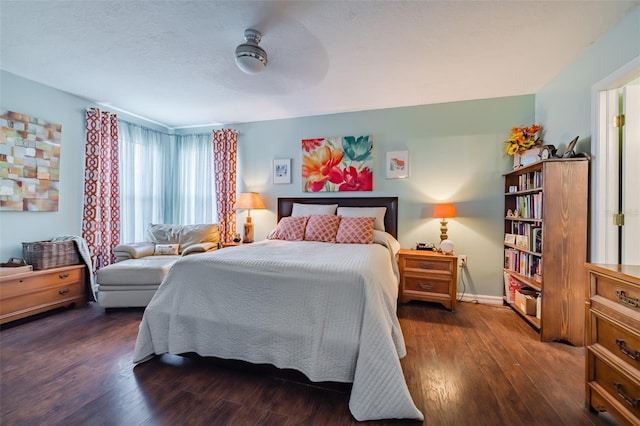 bedroom with dark hardwood / wood-style floors