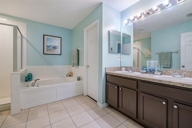 bathroom with independent shower and bath, vanity, and tile patterned floors