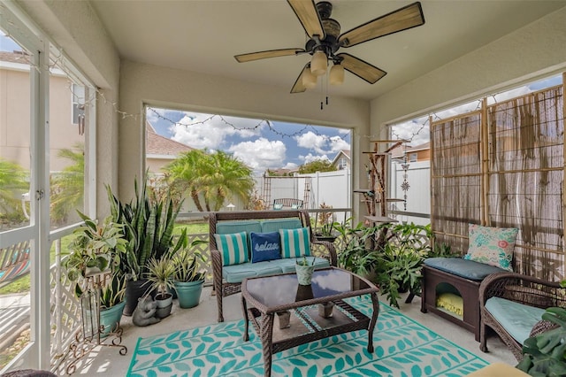 sunroom featuring ceiling fan