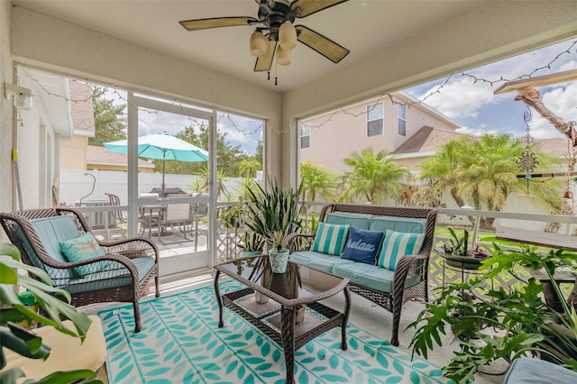 sunroom featuring ceiling fan