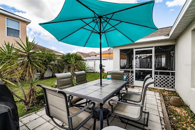 view of patio / terrace featuring a sunroom