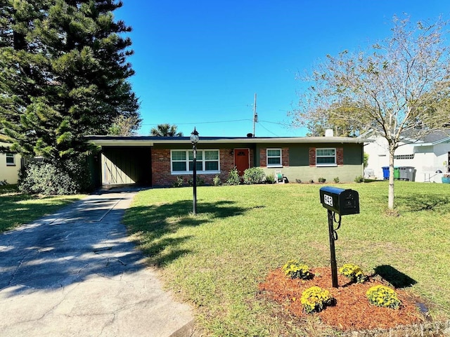 ranch-style house with a front yard and a carport