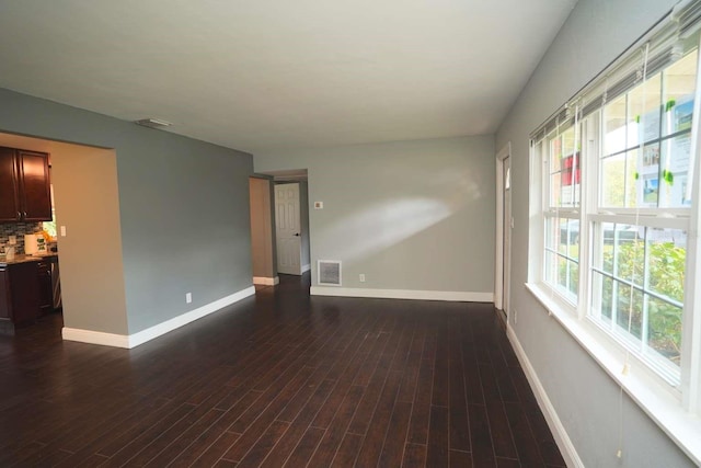 spare room featuring dark hardwood / wood-style flooring