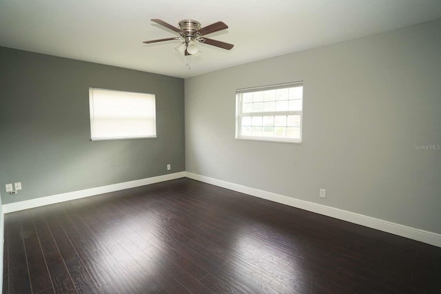 empty room with dark wood-type flooring and ceiling fan