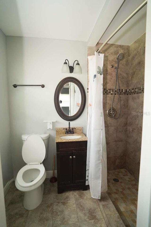 bathroom featuring vanity, toilet, and walk in shower