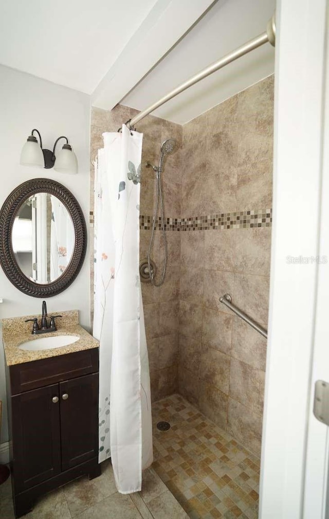 bathroom with vanity and curtained shower