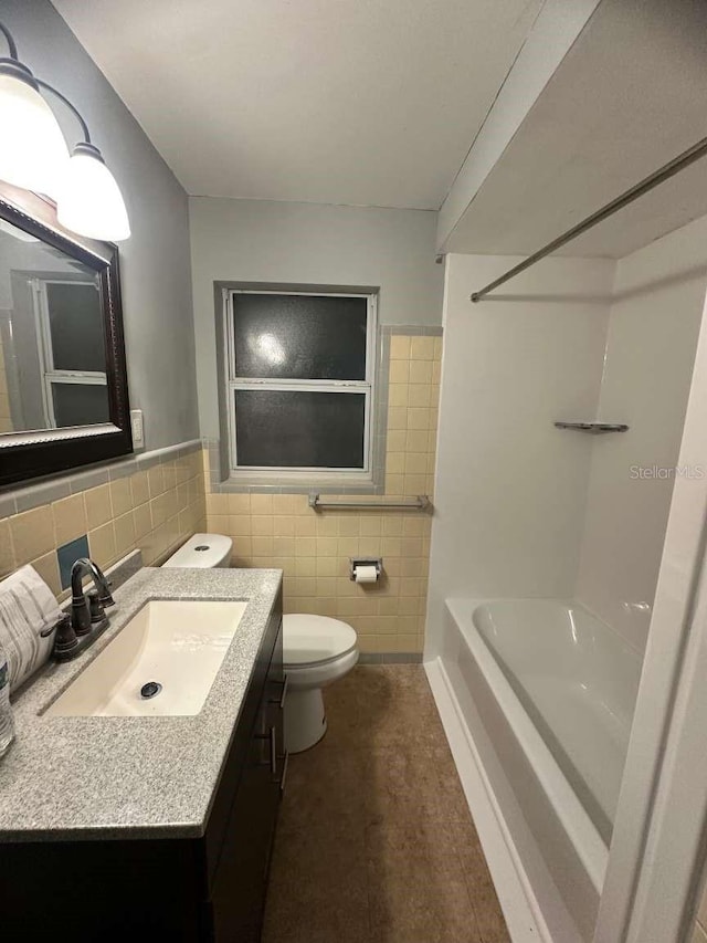 full bathroom with tile walls, vanity,  shower combination, and toilet