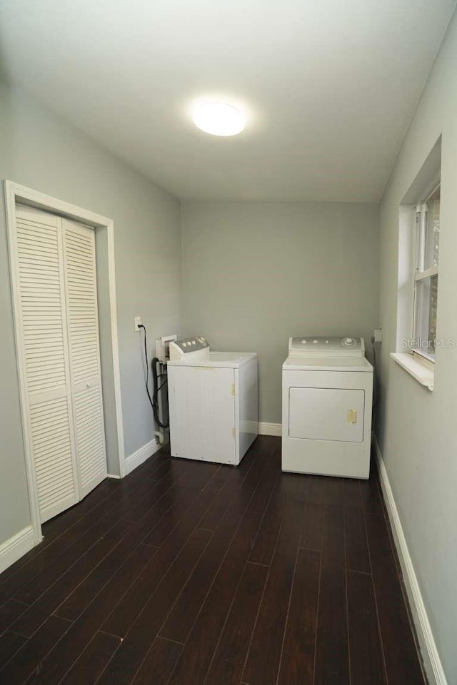 clothes washing area featuring dark hardwood / wood-style flooring and washing machine and dryer