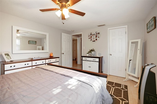 bedroom with light tile patterned flooring and ceiling fan