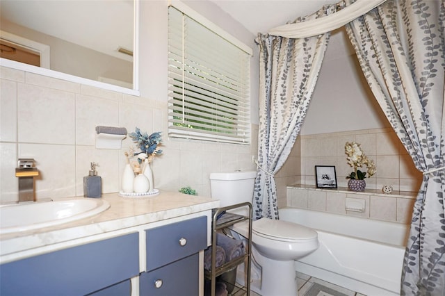 full bathroom with vanity, tile walls, shower / tub combo with curtain, and toilet