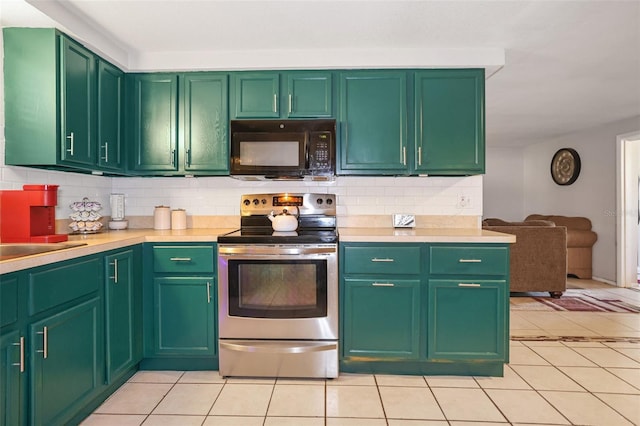 kitchen with light tile patterned flooring, sink, backsplash, green cabinets, and stainless steel electric range