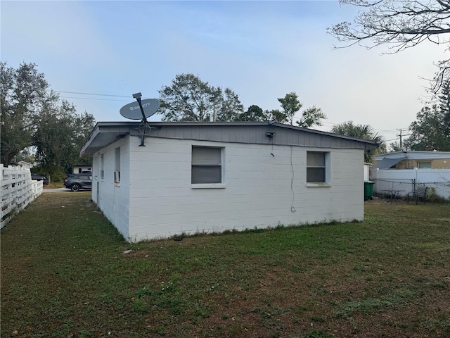 view of side of property with a yard