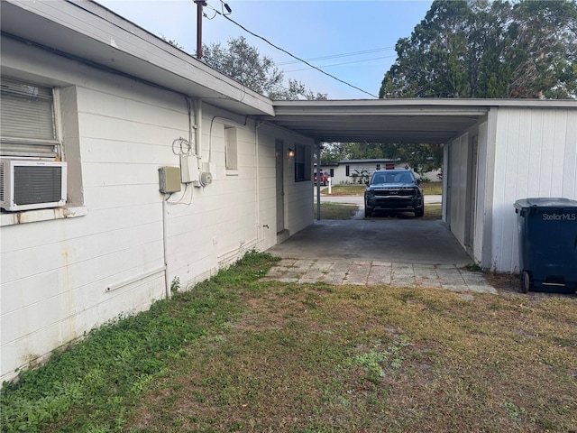 view of property exterior with cooling unit, a lawn, and a carport