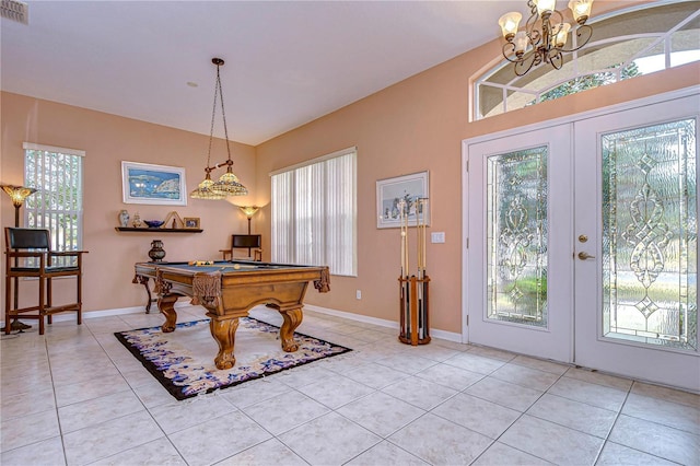 rec room featuring lofted ceiling, light tile patterned floors, a notable chandelier, pool table, and french doors