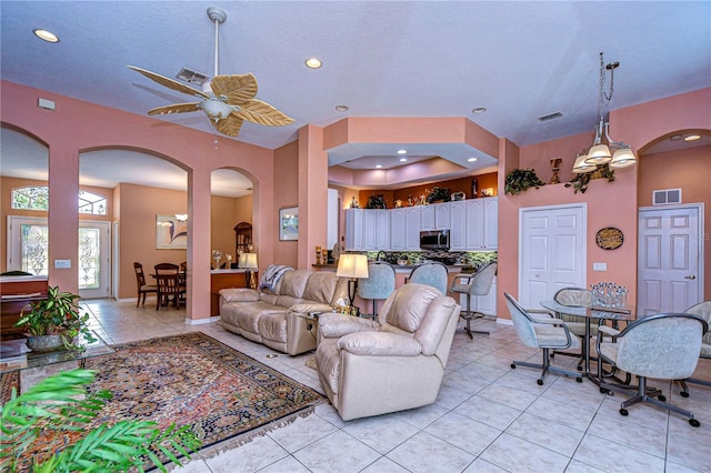 living room featuring light tile patterned floors and ceiling fan