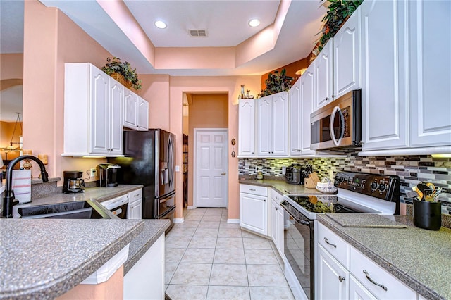 kitchen featuring white cabinetry, appliances with stainless steel finishes, sink, and light tile patterned floors