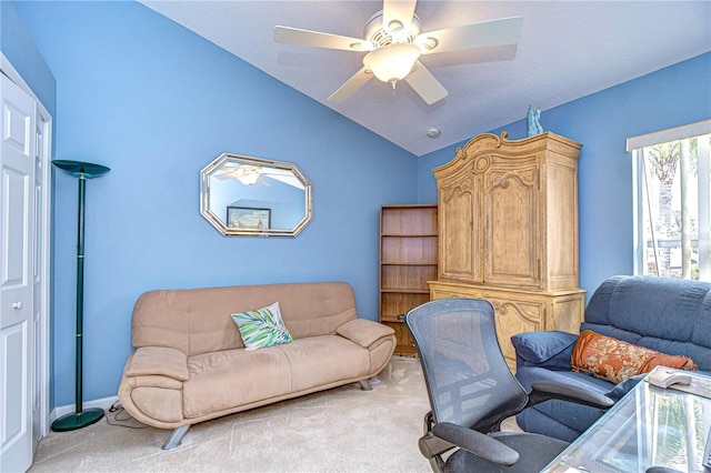 carpeted office featuring lofted ceiling and ceiling fan