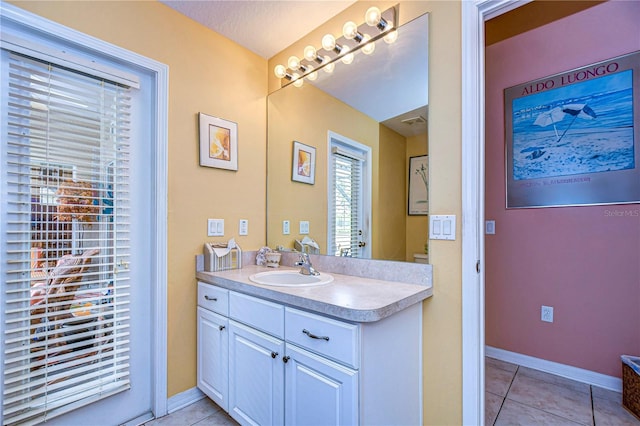 bathroom featuring tile patterned flooring and vanity