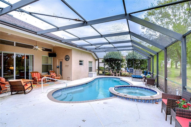 view of pool featuring ceiling fan, glass enclosure, an outdoor living space, a patio area, and an in ground hot tub