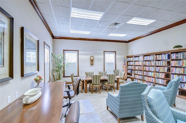 office with crown molding, a paneled ceiling, and carpet