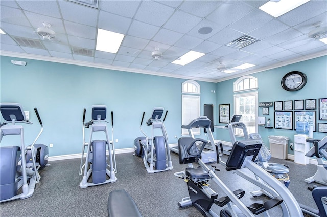 workout area with ornamental molding and a drop ceiling