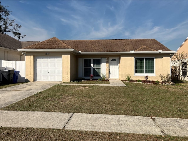 single story home with a garage and a front lawn